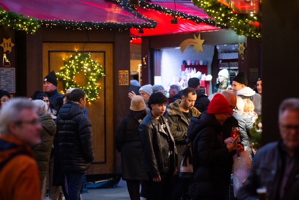 ChristmaVisitors check the stalls selling Christmas decorations at Cologne Christmas in front of Dam Cathedral in Cologne, Germany, on November 18, 2024. (Photo by Ying Tang/NurPhoto) (Photo by Ying Tang / NurPhoto / NurPhoto via AFP)s Market Opens In Cologne