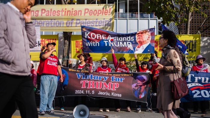 Supporters of former US President and Republican presidential candidate Donald Trump take part in a rally a block away from the US Embassy in Seoul on November 5, 2024. (Photo by Anthony WALLACE / AFP)