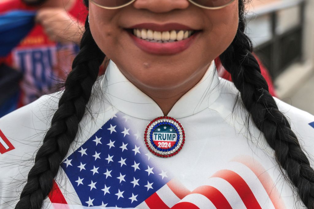 A supporter of former US President and Republican presidential candidate Donald Trump wears a "Trump 2024" pin near his Mar-a-Lago resort in Palm Beach, Florida, on Election Day, November 5, 2024. (Photo by Giorgio Viera / AFP)