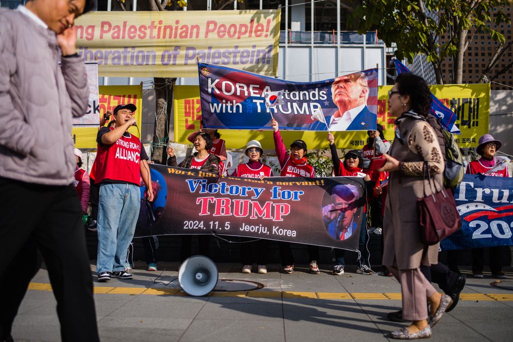 Supporters of former US President and Republican presidential candidate Donald Trump take part in a rally a block away from the US Embassy in Seoul on November 5, 2024. (Photo by Anthony WALLACE / AFP)