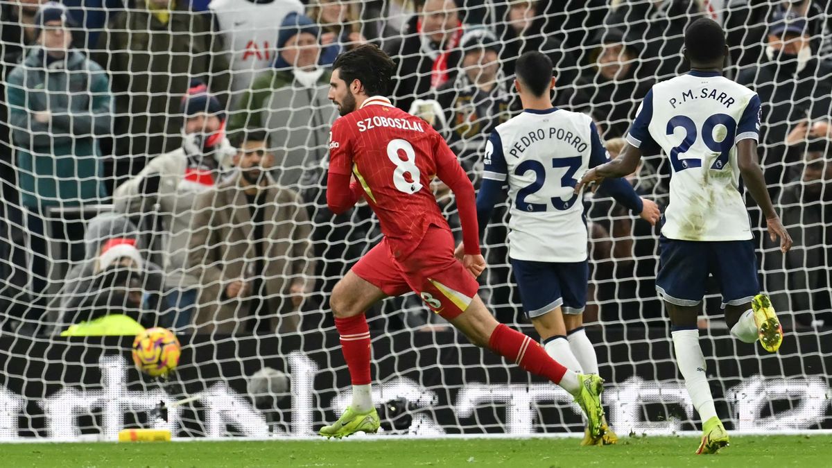 AFP or licensors/Liverpool's Hungarian midfielder #08 Dominik Szoboszlai celebrates scoring their third goal during the English Premier League football match between Tottenham Hotspur and Liverpool at the Tottenham Hotspur Stadium in London, on December 22, 2024. (Photo by Glyn KIRK / AFP) / RESTRICTED TO EDITORIAL USE. No use with unauthorized audio, video, data, fixture lists, club/league logos or 'live' services. Online in-match use limited to 120 images. An additional 40 images may be used in extra time. No video emulation. Social media in-match use limited to 120 images. An additional 40 images may be used in extra time. No use in betting publications, games or single club/league/player publications. / 