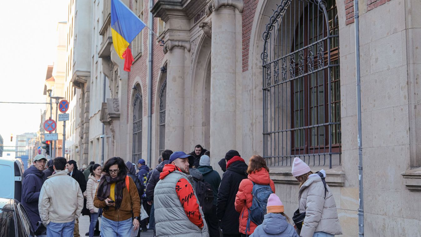 People queue in front of the Romanian embassy in Berlin to vote during the Romanian parliamentary election on December 1, 2024. Still reeling from this week's shock developments, Romanians returned to the polls on December 1 to elect their parliament, with the far right tipped to win, potentially heralding a shift in the NATO country's foreign policy. (Photo by Anton Roland LAUB / AFP)