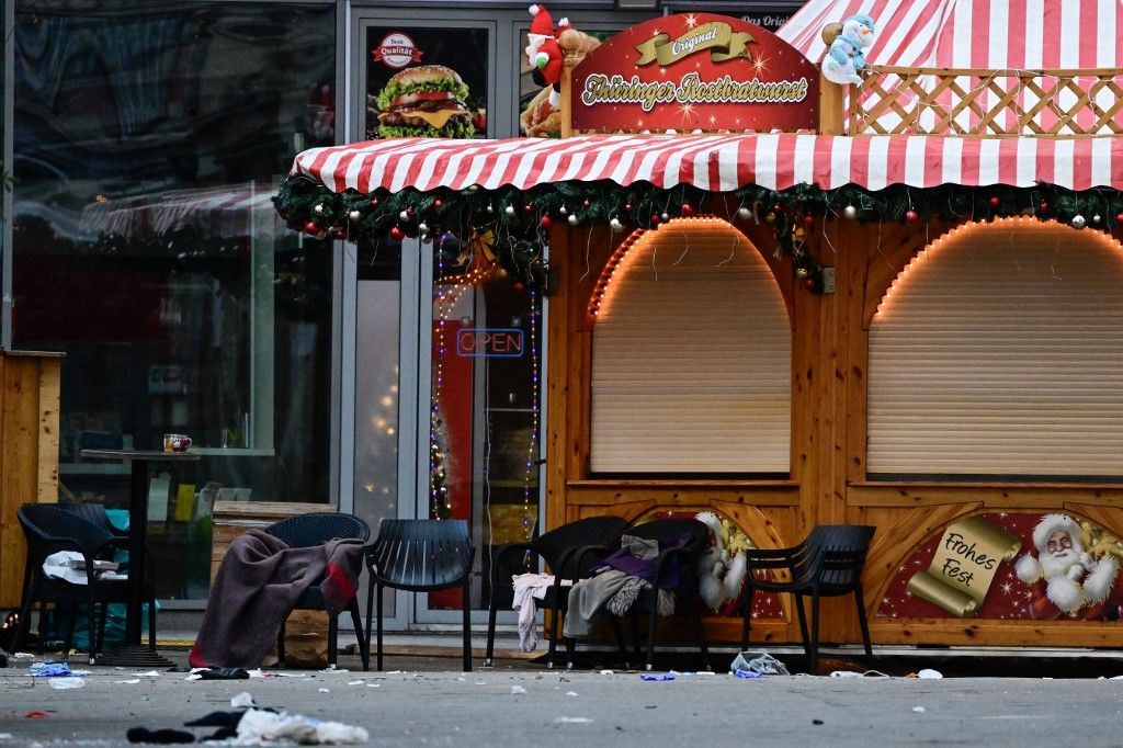 AFP or licensors/Empty chairs with abandoned blankets and debris are seen at a closed Christmas market where a car crashed into a crowd killing two and injuring more than 60 people the evening before, on early December 21, 2024 in Magdeburg, eastern Germany. At least one person was killed and 68 injured December 20, 2024 in a suspected attack on a Christmas market in the eastern Germany city of Magdeburg, local authorities said. (Photo by John MACDOUGALL / AFP)