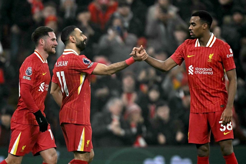 AFP or licensors/Liverpool's Egyptian striker #11 Mohamed Salah celebrates scoring the team's third goal with Liverpool's Dutch midfielder #38 Ryan Gravenberch (R) during the English Premier League football match between Liverpool and Leicester City at Anfield in Liverpool, north west England on December 26, 2024. (Photo by Paul ELLIS / AFP) / RESTRICTED TO EDITORIAL USE. No use with unauthorized audio, video, data, fixture lists, club/league logos or 'live' services. Online in-match use limited to 120 images. An additional 40 images may be used in extra time. No video emulation. Social media in-match use limited to 120 images. An additional 40 images may be used in extra time. No use in betting publications, games or single club/league/player publications. / 