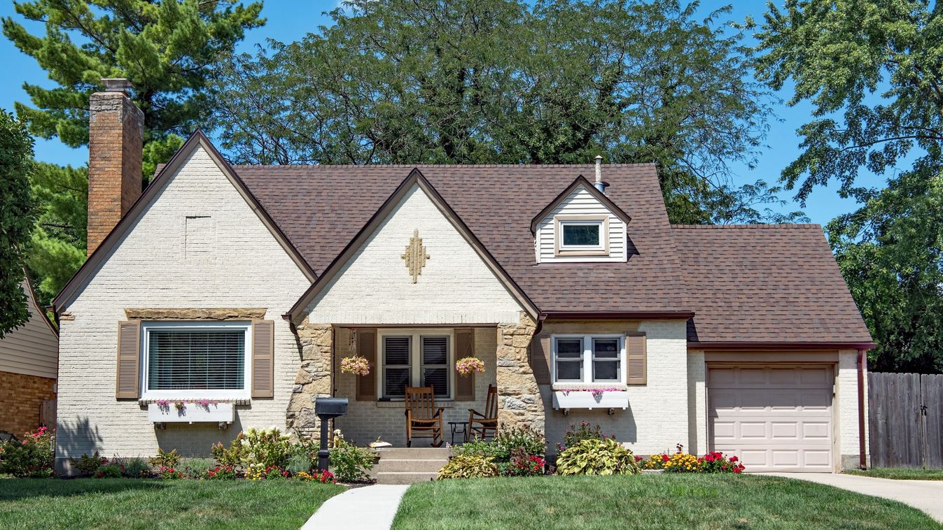 Modest,,Two-story,,Tan,Brick,And,Flagstone,House,With,Large,Flowerbed