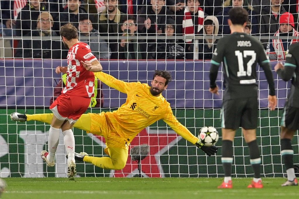 Girona's Dutch defender #17 Daley Blind's shot is stopped by Liverpool's Brazilian goalkeeper #01 Alisson Becker during the UEFA Champions League, league phase football match between Girona FC and Liverpool FC at the Montilivi stadium in Girona on December 10, 2024. (Photo by MANAURE QUINTERO / AFP)