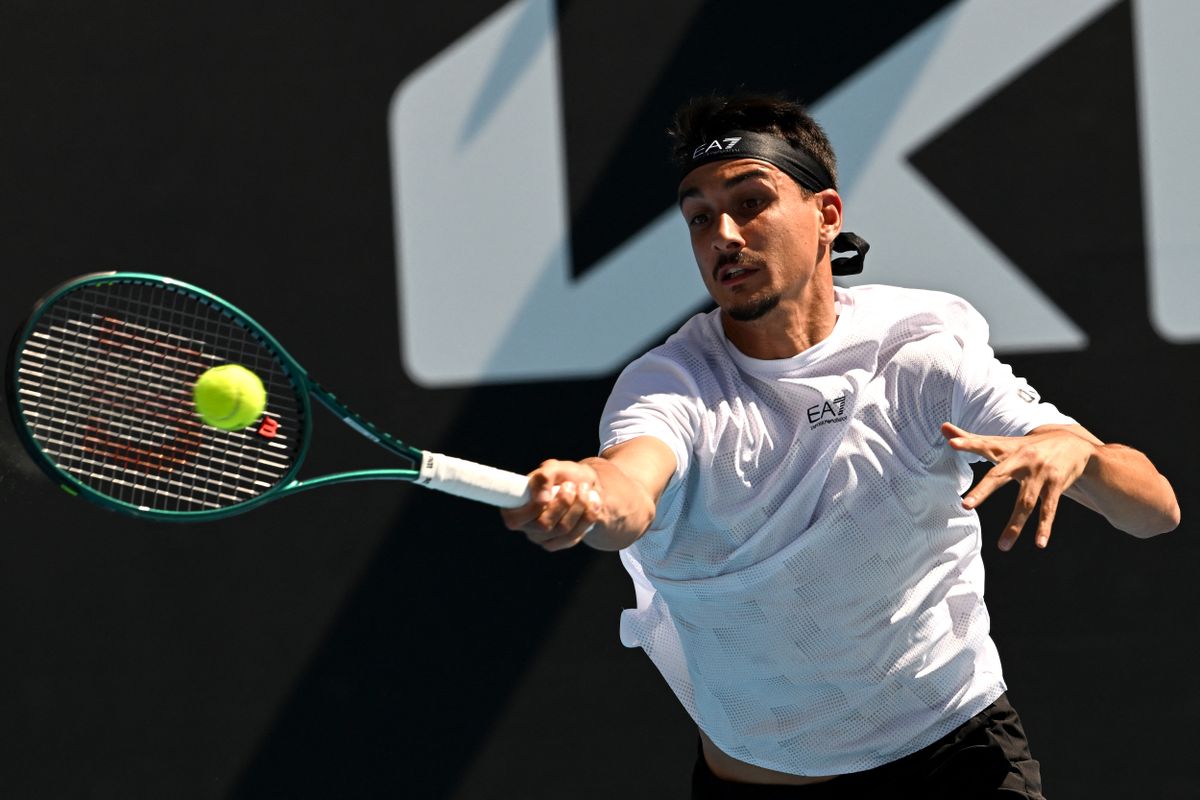 Italy's Lorenzo Sonego hits a return against Hungary's Marozsán Fábián magyar tenisz during their men's singles match on day seven of the Australian Open tennis tournament in Melbourne on January 18, 2025. (Photo by Paul Crock / AFP) / -- 