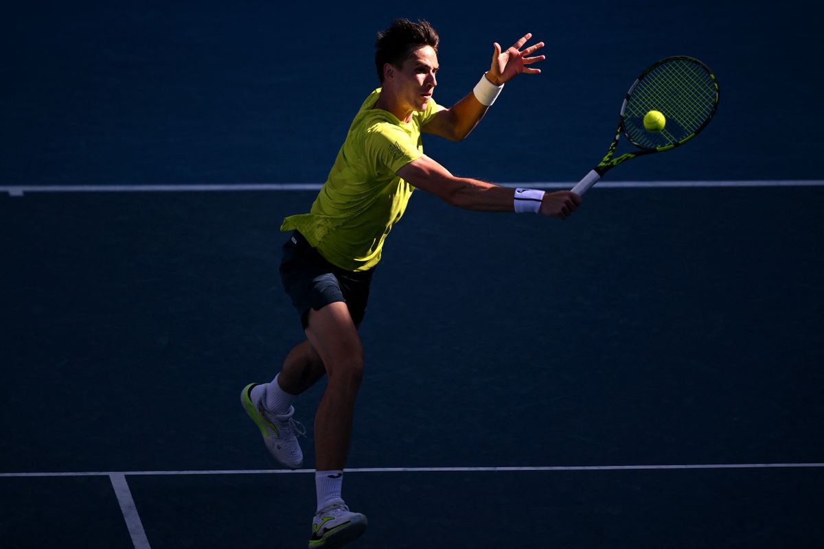 Hungary's Fabian Marozsan hits a return against USA's Frances Tiafoe during their men's singles match on day five of the Australian Open tennis tournament in Melbourne on January 16, 2025. (Photo by WILLIAM WEST / AFP) / - Lorenzo Sonego Rafael Nadal Novak Djokovics