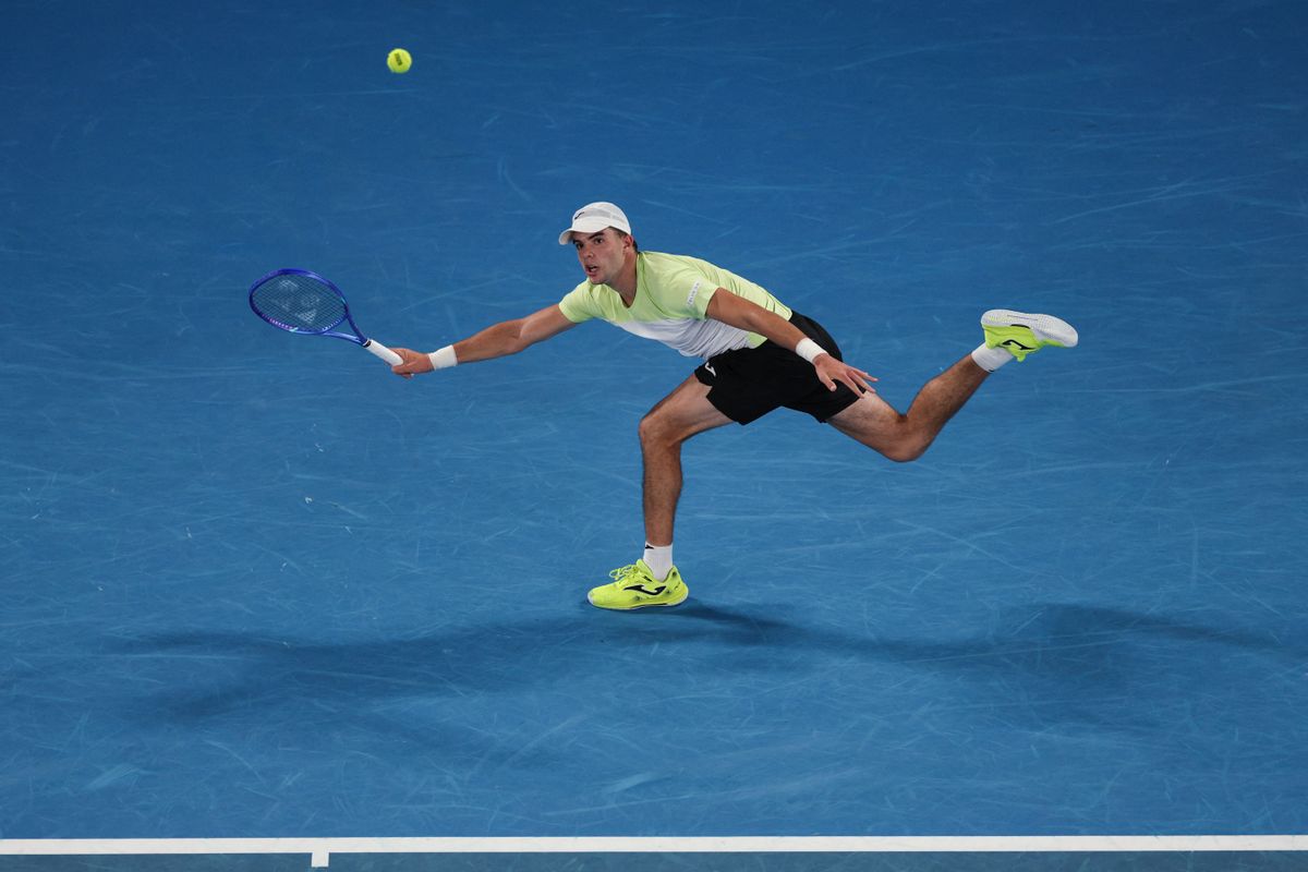 Portugal's Jaime Faria hits a return against Serbia's Novak Djokovics Grand Slam during their men's singles match on day four of the Australian Open tennis tournament in Melbourne on January 15, 2025. (Photo by Adrian DENNIS / AFP) / -- IMAGE RESTRICTED TO EDITORIAL USE - STRICTLY NO COMMERCIAL USE --