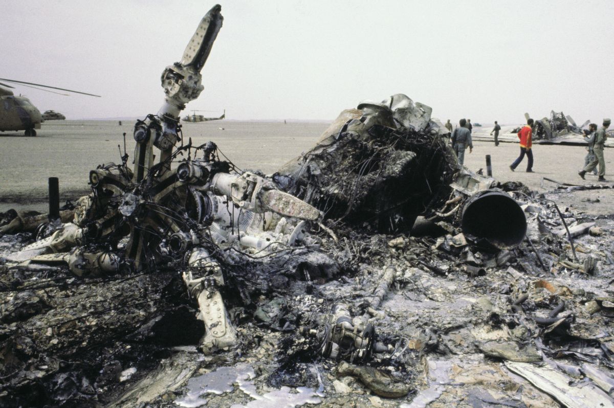 Lugas
(Original Caption) Robat-E-Posht-E Badam, Iran: One of the US helicopters in the failed attempt to rescue the US hostages in Tehran lies in ruins near this desert oasis. An intact helicopter is seen behind the wreckage.