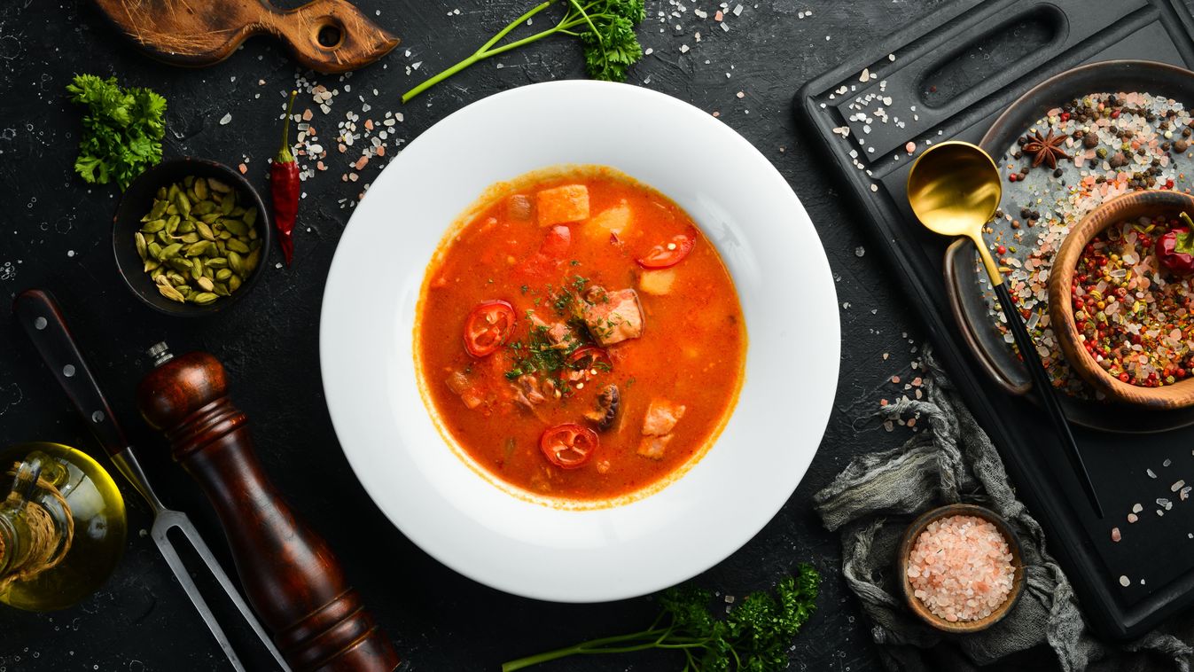 Bograch soup. Hungarian cuisine. Soup with meat, vegetables and chili peppers. In a white plate. Top view.