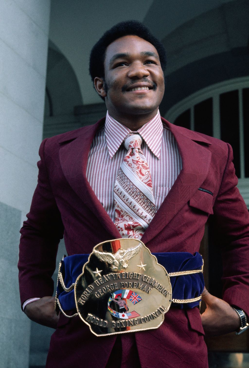 (Original Caption) Heavyweight champion thanks to a knockout of Joe Frazier in Kingston, Jamaica, 1/22, George Foreman sports his championship belt.