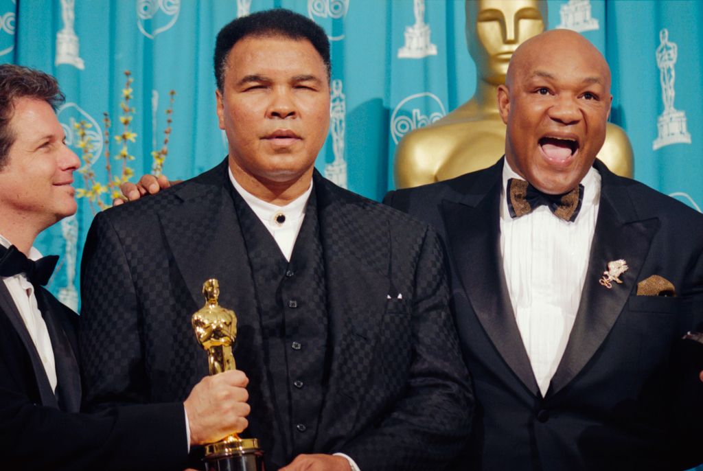 (Original Caption) Boxers Muhammad Ali and George Foreman were the subjects of the Documentary Feature winner When We Were Kings, produced by David Sonenberg (left). The hold their winning Oscar backstage at the 69th annual Academy Awards. (Photo by �� St