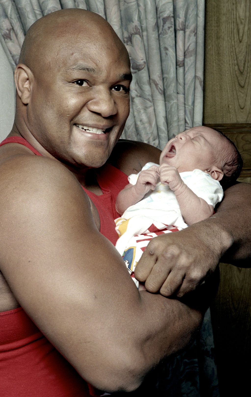 American Former World Heavyweight boxing champion George Foreman holds his week-old son, George Foreman III, Houston, Texas, 29th January 1983. All five of Foreman's sons boys are called George. George Foreman III is also known as 'Monk'. (Photo by Michae