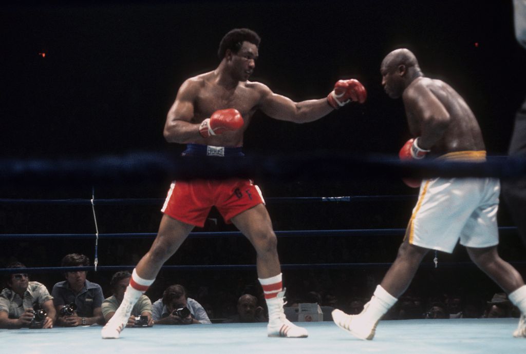 UNIONDALE,NY - JUNE 15,1976: George Foreman (L) throws a punch against Joe Frazier during the fight at Nassau Coliseum in Uniondale, New York. George Foreman won the NABF heavyweight title by a TKO 5. (Photo by: The Ring Magazine via Getty Images)