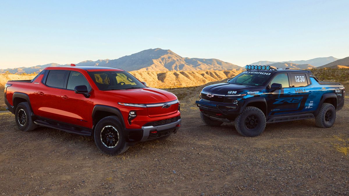 Front 3/4 view of the Chevrolet Silverado EV Trail Boss in Habanero Orange exterior color and Silverado EV ZR2 race truck concept.