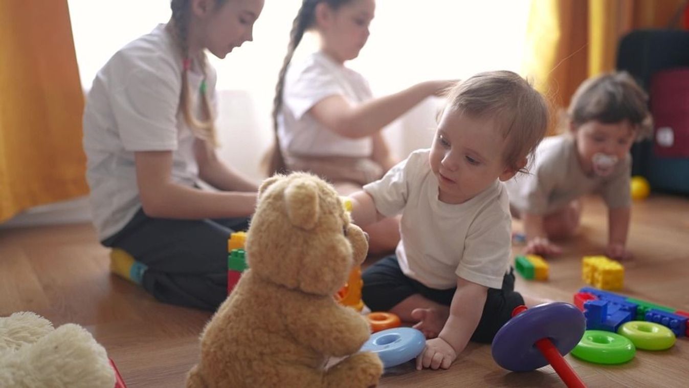 group of baby children playing toys on lifestyle floor indoors. happy family kindergarten kid dream concept. group children playing in kindergarten indoors toddlers and babies and kids into toys