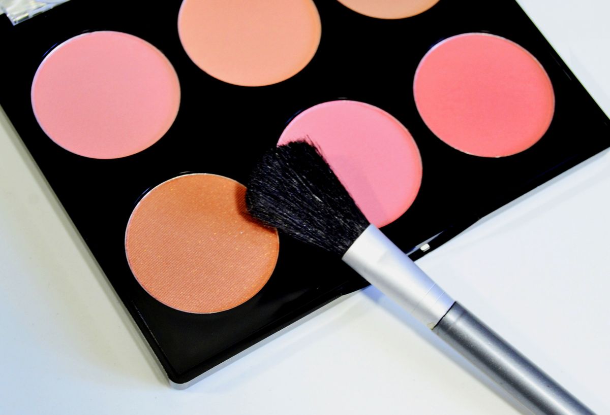 Different blush and makeup bases on white background, close-up