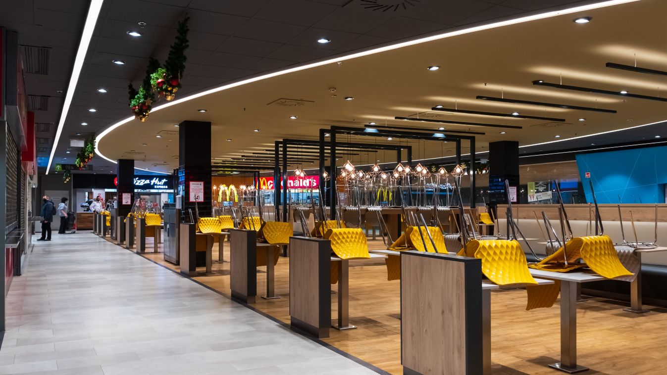 Debrecen, Hungary - December 27, 2020: Wide angle view of empty food court at Debrecen Plaza shopping mall. No dine-in, only takeaways permitted. Covid-19 coronavirus outbreak.