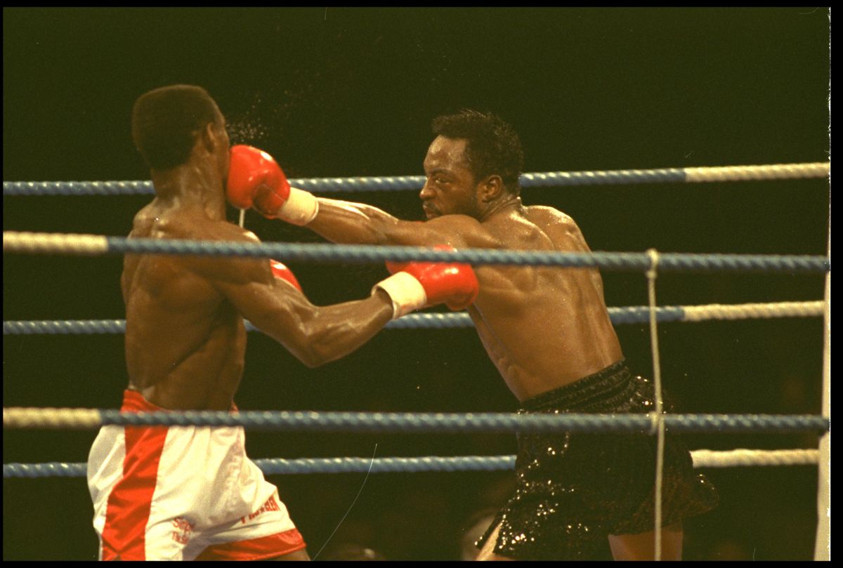18 NOV 1990: NIGEL BENN (RIGHT) CONNECTS WITH A VICIOUS LEFT HAND JAB TO THE FACE OF CHRIS EUBANK DURING THE WBO WORLD MIDDLEWEIGHT TITLE FIGHT AT BIRMINGHAM. CHRIS EUBANK WON THE FIGHT IN ROUND 9.