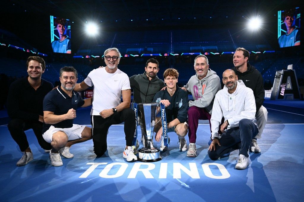 Italy's Jannik Sinner (4thR) poses with members of his staff, Darren Cahill (3edR), Australian tennis coach, Marco Panichi (3rdL), fitness coach,  after winning the final against USA's Taylor Fritz at the ATP Finals tennis tournament in Turin on November 17, 2024. (Photo by Marco BERTORELLO / AFP)