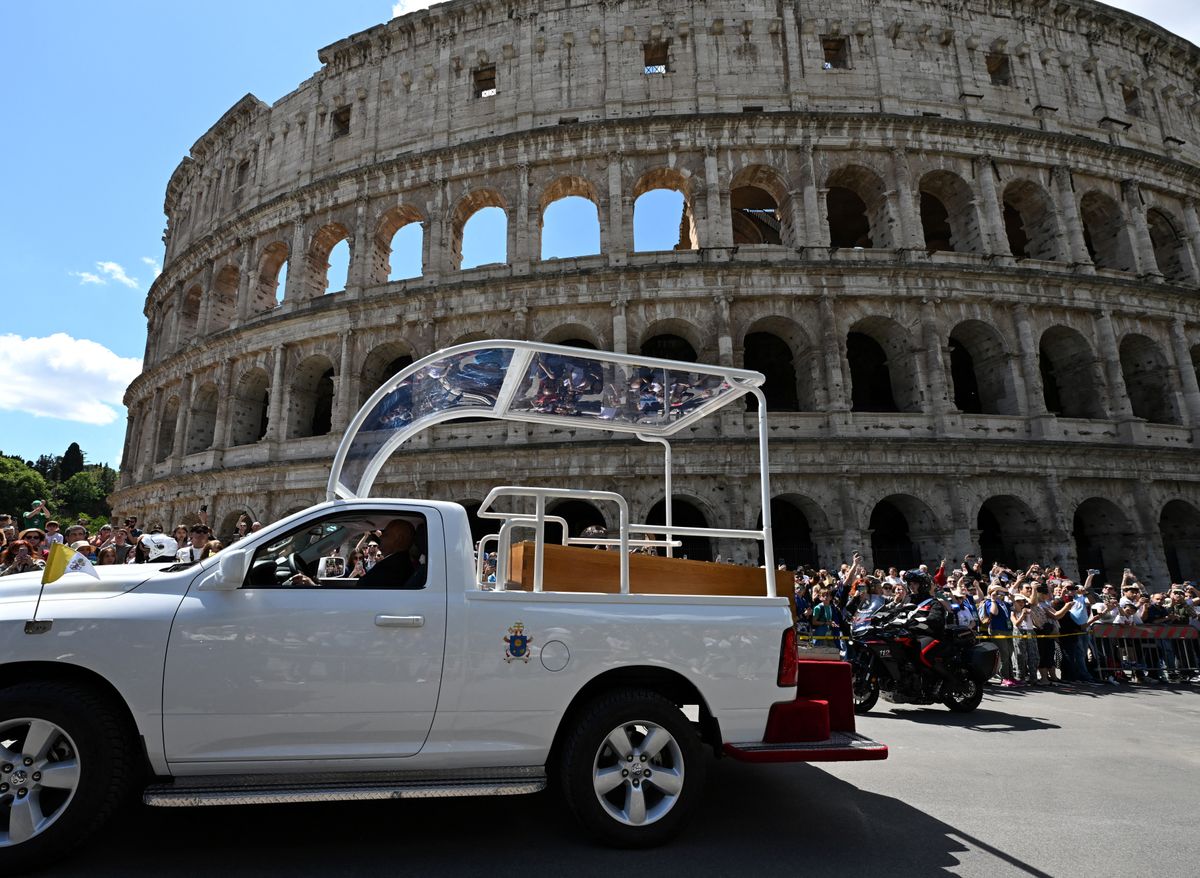 The coffin of late Pope Francis is seen in front of the Colosseum as it is transported from St Peter's Basilica to Santa Maria Maggiore Basilica, during the funeral ceremony in Rome on April 26, 2025. (Photo by Stefano Rellandini / AFP)