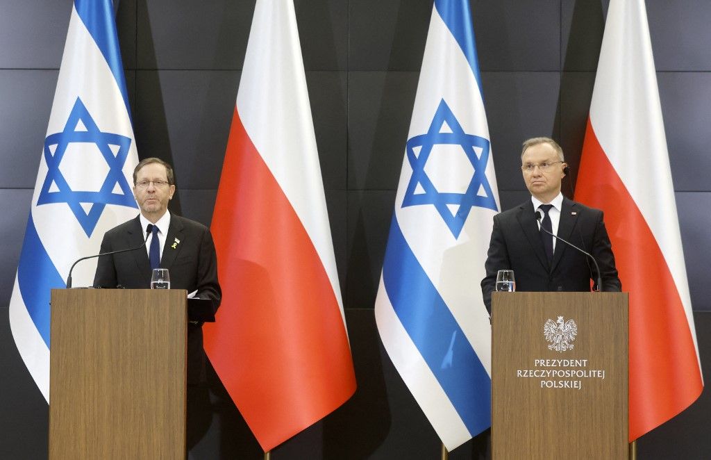 Poland's President Andrzej Duda (R) and Israel's President Isaac Herzog give a press statement at the International Centre for Education about Auschwitz and the Holocaust, at the Auschwitz-Birkenau Museum and Memorial at the site of the former German Nazi concentration and extermination camp in Oswiecim, Poland, on April 24, 2025, prior to the March of the Living to honour the victims of the Holocaust. The March of the Living in 2025 from the former Auschwitz I to Auschwitz II-Birkenau camps is dedicated to the 80th anniversary of the end of World War II and the liberation of the concentration camps in Nazi-occupied Europe, according to organisers. (Photo by Wojtek RADWANSKI / AFP)