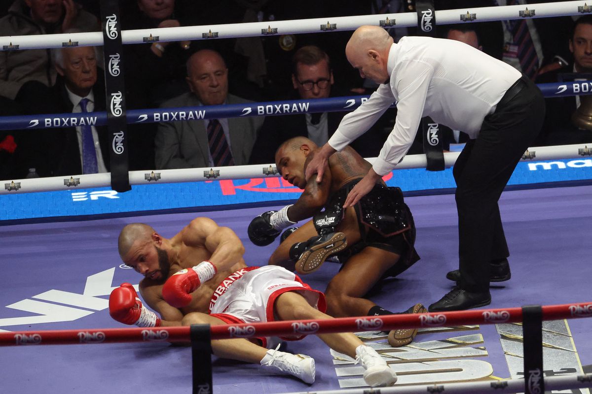 Britain's Chris Eubank Jr and Britain's Conor Benn fall while fighting during their middleweight boxing match at the Tottenham Hotspur stadium in London on April 26, 2025. (Photo by DARREN STAPLES / AFP)