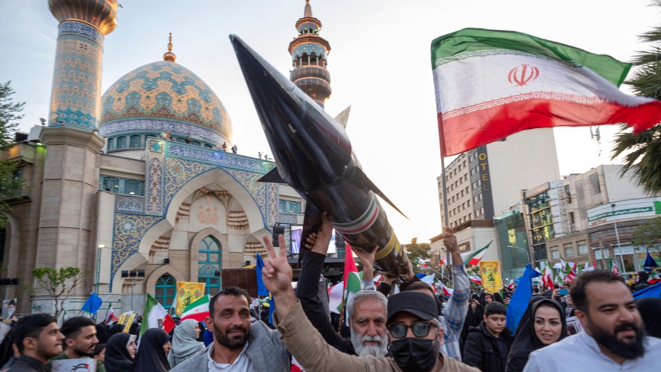 Unidentified men are carrying a model of Iran's first-ever hypersonic missile, Fattah, past a mosque during a gathering to celebrate the IRGC UAV and missile attack against Israel, in Tehran, Iran, on April 15, 2024. Iran launched dozens of Unmanned Aeria