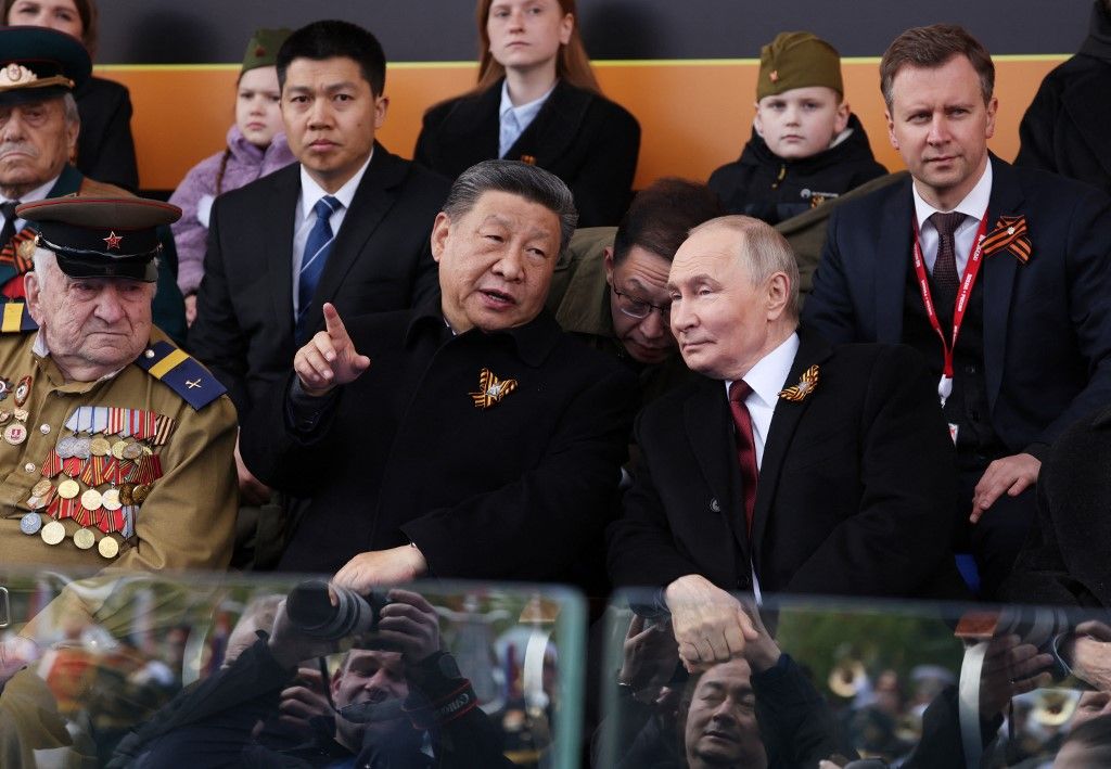 In this pool photograph distributed by the Russian state agency Sputnik, Russia's President Vladimir Putin and Chinese President Xi Jinping attend the Victory Day military parade at Red Square in central Moscow on May 9, 2025. Russia celebrates the 80th anniversary of the Soviet Union's victory over Nazi Germany in World War Two (WWII). (Photo by Vyacheslav PROKOFYEV / POOL / AFP)