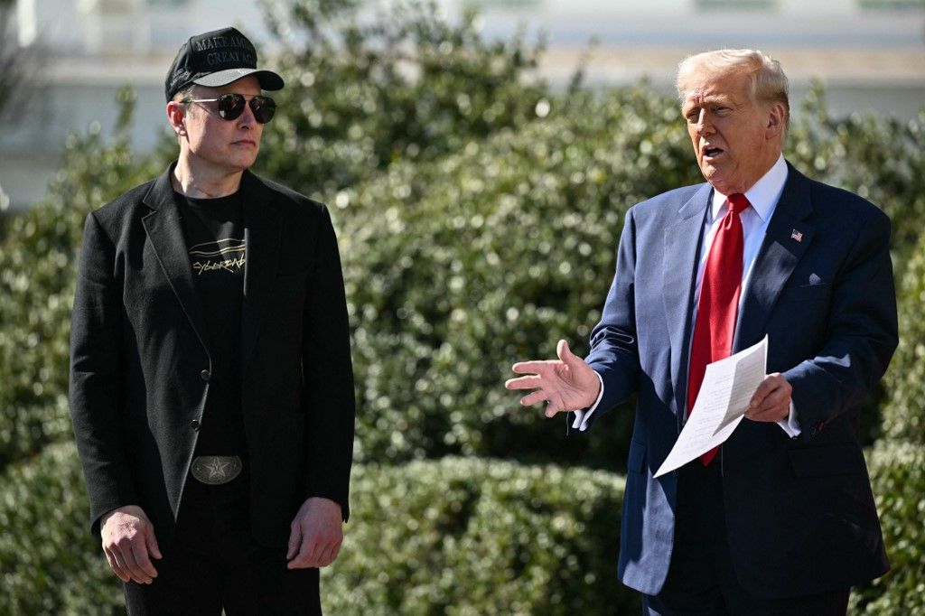 (FILES) US President Donald Trump and Tesla CEO Elon Musk speak to the press as they stand next to a Tesla vehicle on the South Portico of the White House on March 11, 2025 in Washington, DC. US President Donald Trump announced that he and Elon Musk would address the media on May 30 on the "terrific" South African-born billionaire's last day at the so-called Department of Government Efficiency (DOGE). (Photo by Mandel NGAN / AFP)