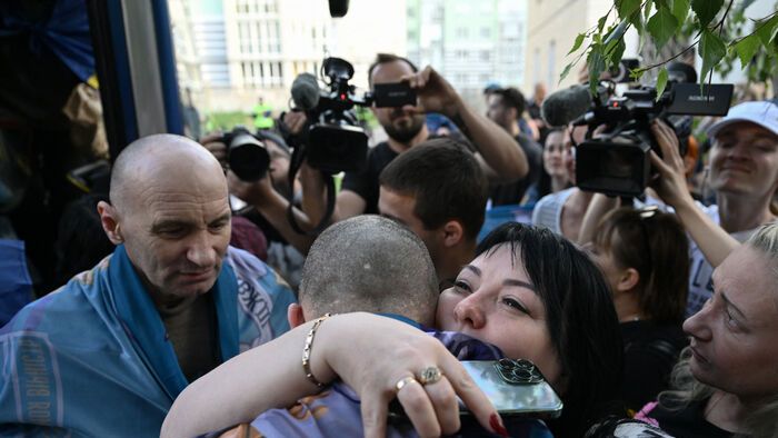 A woman hugs a freed Ukrainian POW upon his arrival after a prisoner exchange in the Chernygiv region on May 23, 2025, amid the Russian invasion of Ukraine. Ukraine and Russia began a major prisoner exchange on May 23, 2025, which if completed would be the biggest swap since Moscow invaded more than three years ago. Both sides received 390 people in the first stage on May 23, and are expected to exchange 1,000 each in total under an agreement reached at direct talks in Istanbul the previous week. The process is set to last three days, Kyiv said. (Photo by Genya SAVILOV / AFP)