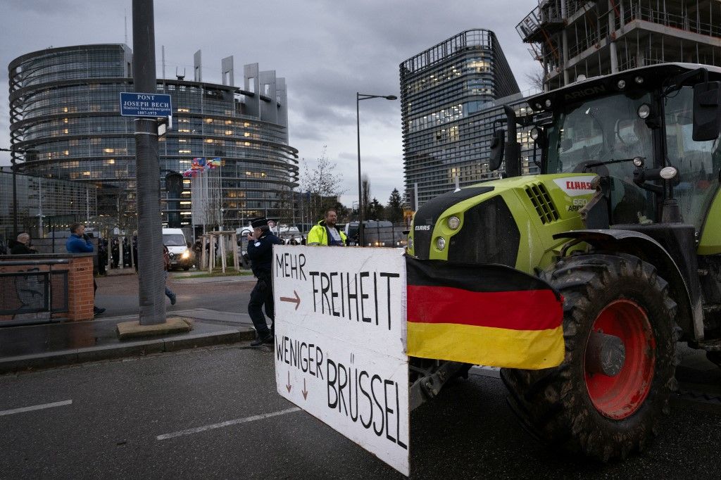 A protester drives a tractor displaying a banner reading "More Freedom, less Brussels" past the European Parliament as French farmers take part in a rally organised by the Coordination Rurale, a French farmers' union, to protest against the EU-Mercosur agreement, in Strasbourg, eastern France, on December 19, 2024. (Photo by SEBASTIEN BOZON / AFP)