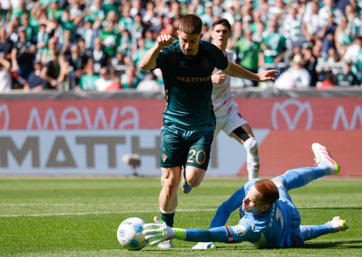Bremen's Austrian midfielder #20 Romano Schmid (L) and Leipzig's Hungarian goalkeeper #01 Peter Gulacsi vie for the ball during the German first division Bundesliga football match between SV Werder Bremen and RB Leipzig in Bremen, northern Germany on May 10, 2025. (Photo by Focke Strangmann / AFP) / DFL REGULATIONS PROHIBIT ANY USE OF PHOTOGRAPHS AS IMAGE SEQUENCES AND/OR QUASI-VIDEO