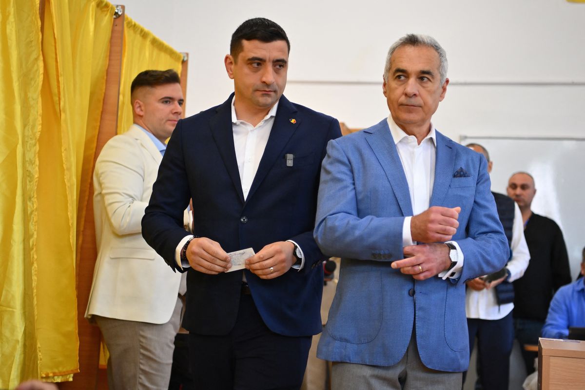 Leader of nationalist sovereign party 'Alliance for the Union of Romanians' AUR George Simion casts his ballot next to former candidate Calin Georgescu during the first round of the presidential election in Mogosoaia on May 4, 2025. (Photo by Alex Nicodim/NurPhoto) (Photo by Alex Nicodim / NurPhoto / NurPhoto via AFP)