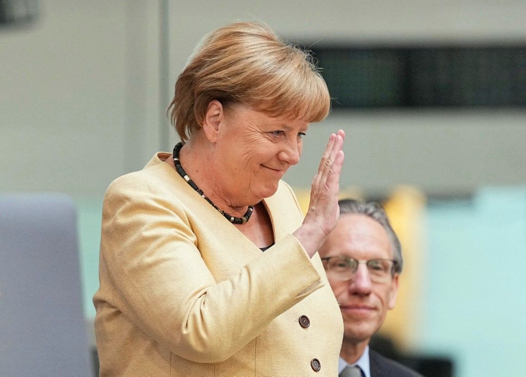06 May 2025, Berlin: Angela Merkel (CDU), former Federal Chancellor, waves to Jörg Kukies (SPD), Acting Federal Minister of Finance, in the gallery before the election of the Chancellor in the Bundestag. The election and swearing-in of the Federal Chancellor and the new Federal Government takes place in the Bundestag. Photo: Michael Kappeler/dpa (Photo by MICHAEL KAPPELER / DPA / dpa Picture-Alliance via AFP)