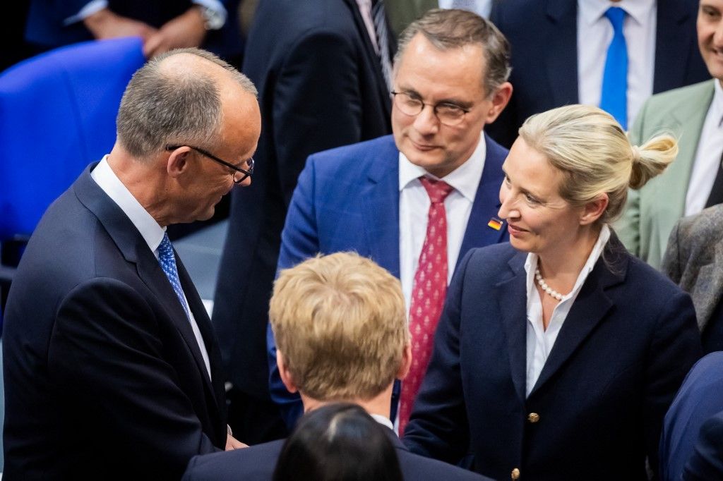06 May 2025, Berlin: Alice Weidel (r), Co-Chair of the AfD parliamentary group, in the presence of Tino Chrupalla (M, back), Co-Chair of the AfD parliamentary group, congratulates the newly elected Federal Chancellor Friedrich Merz (CDU, l) after his election in the second round of voting. Friedrich Merz has been elected as the tenth Chancellor of the Federal Republic of Germany in the second round of voting in the Bundestag. Photo: Christoph Soeder/dpa (Photo by Christoph Soeder / DPA / dpa Picture-Alliance via AFP)
