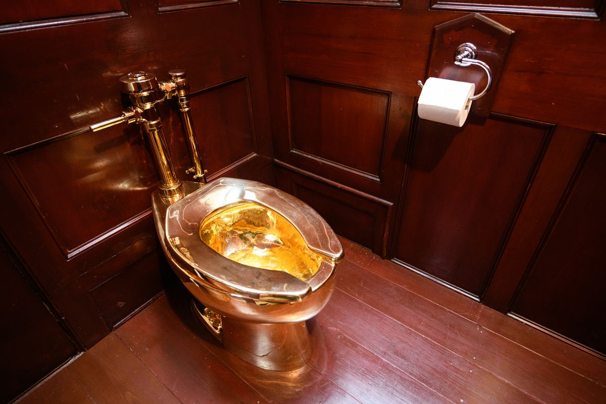 WOODSTOCK, ENGLAND - SEPTEMBER 12: "America", a fully-working solid gold toilet, created by Maurizio Cattelan, is seen at Benheim Palace on September 12, 2019 in Woodstock, England. The artwork is still missing following what police believe to be a burglary on September 14, in which the toilet, valued by some at £4.8million, was taken. In 1996, Cattelan famously stole the entire contents of one of his own exhibitions in Amsterdam but has strongly denied any involvement with this latest theft. (Photo by Leon Neal/Getty Images)