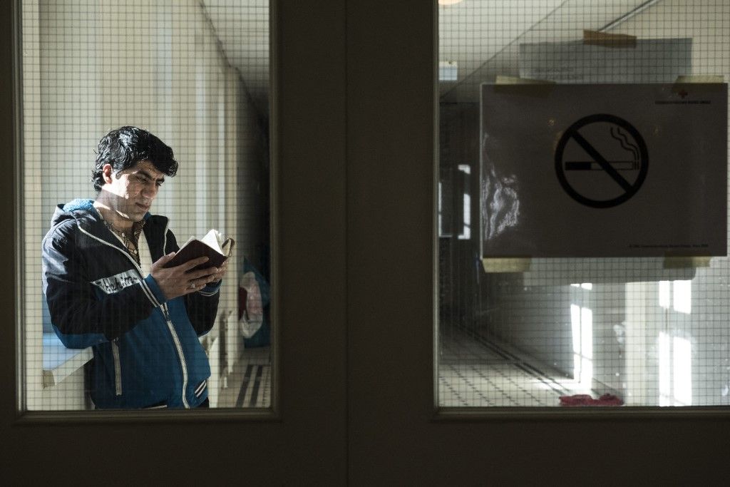 VIENNA, AUSTRIA - FEBRUARY 11: An Afghan refugee, who has served in the special forces of the Afghanistan Army and a translator for the American army in Afghanistan for 6 years, is seen as he waits to be granted an asylum status at the Red Cross shelter, in Vienna, Austria on February 11, 2016. The refugee shelter is located right in the Vienna city centre, inside the building belonging to the University of Applied Arts. The premises were rented by the university to the Austrian Red Cross in 2015. According to this agreement, the shelter started operating in October 2015 and it will be open until May 2016. The Red Cross shelter has a capacity to host 1400 persons and 775 refugees live there. Around 90% of the refugees living in the shelter come from Iraq, Syria or Afghanistan. Over the last seven months, around 90,000 asylum seekers have applied for refuge in Austria, and at least 50,000 of these are expected to be deported. Military aircraft have been requisitioned for this purpose. The government also wants to cut social support to these asylum seekers. Omar Marques / Anadolu Agency (Photo by Omar Marques / ANADOLU AGENCY / Anadolu via AFP)