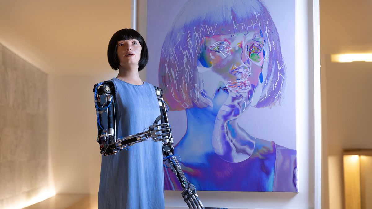 LONDON, ENGLAND - MAY 18: Ai-Da stands in front of one of 'her' artworks during "Ai-Da: The World's First Robot Artist" press view at Design Museum on May 18, 2021 in London, England. AI-DA is on display until August 29, 2021 at The Design Museum. (Photo by Tim P. Whitby/Getty Images)