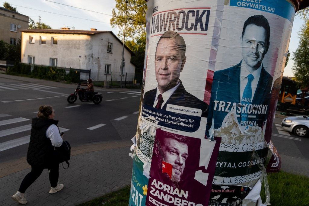 (FILES) Electoral posters of Warsaw's mayor and member of Polands ruling Civic Coalition party Rafal Trzaskowski (R), Karol Nawrocki (L) - candidate for the 2025 Polish presidential election supported by Poland's right-wing Law and Justice (PiS) party and left wing candidate Adrian Zandberg are seen on the street of Warsaw on May 6, 2025. A large water park has pride of place in the heart of Polish village Kleszczow -- an apparent sign of the prosperity of the area known as "the Polish Kuwait". But residents worry these riches will come to an end. That was a chief concern when they overwhelmingly voted for the far-right in round one of the presidential election this month. The far-right is now playing kingmaker ahead of the June 1 runoff, which will pit pro-EU Warsaw mayor Rafal Trzaskowski against nationalist historian Karol Nawrocki. (Photo by Wojtek RADWANSKI / AFP)