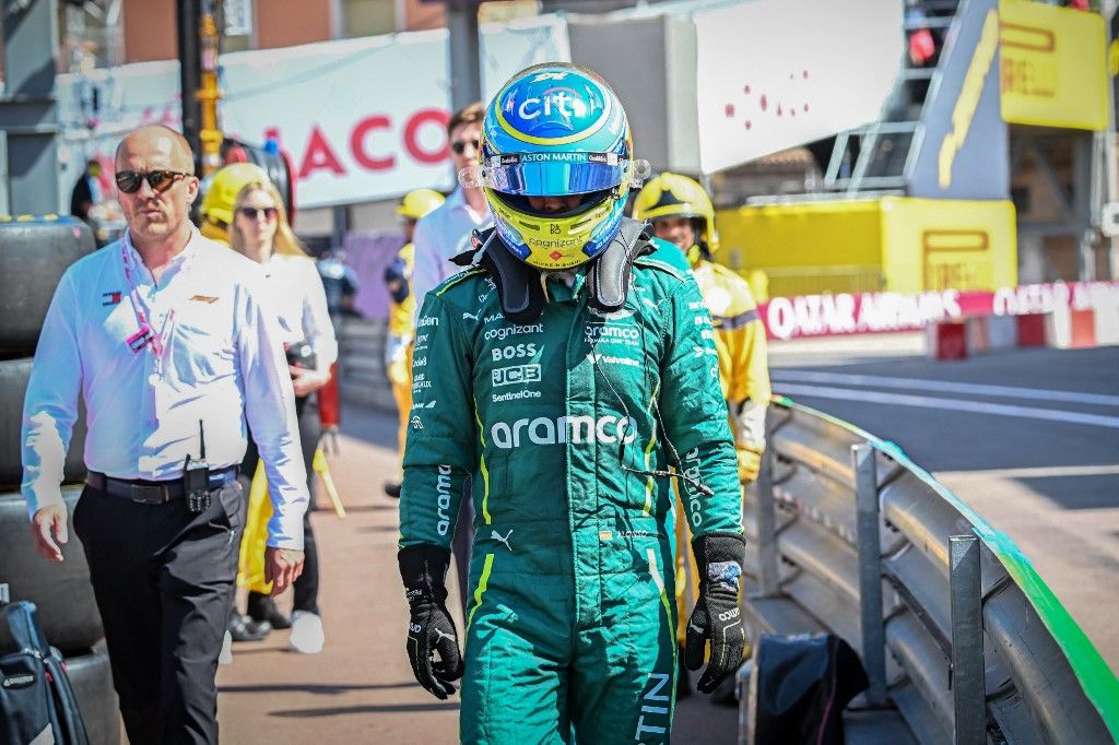 Aston Martin's Spanish driver Fernando Alonso walks back to the pits after retiring during the Formula One Monaco Grand Prix at the Circuit de Monaco, on May 25, 2025. (Photo by Gabriel BOUYS / POOL / AFP)