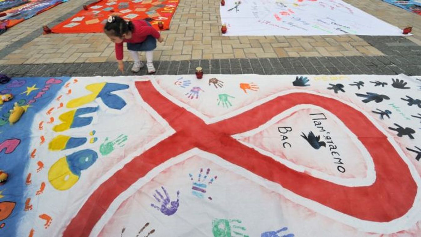  girl looks at quilts laid out in Kyiv’s Mikhaylovskaya Square on May 13, 2011. The quilts were made by people living with HIV in memory of AIDS victims in Ukraine. (Photo: AFP)