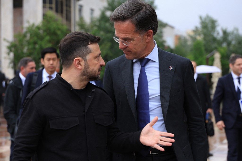 Ukraine's President Volodymyr Zelensky (L) speaks with NATO Secretary General Mark Rutte during the European Political Community (EPC) summit, in Tirana on May 16, 2025. (Photo by Adnan Beci / AFP)