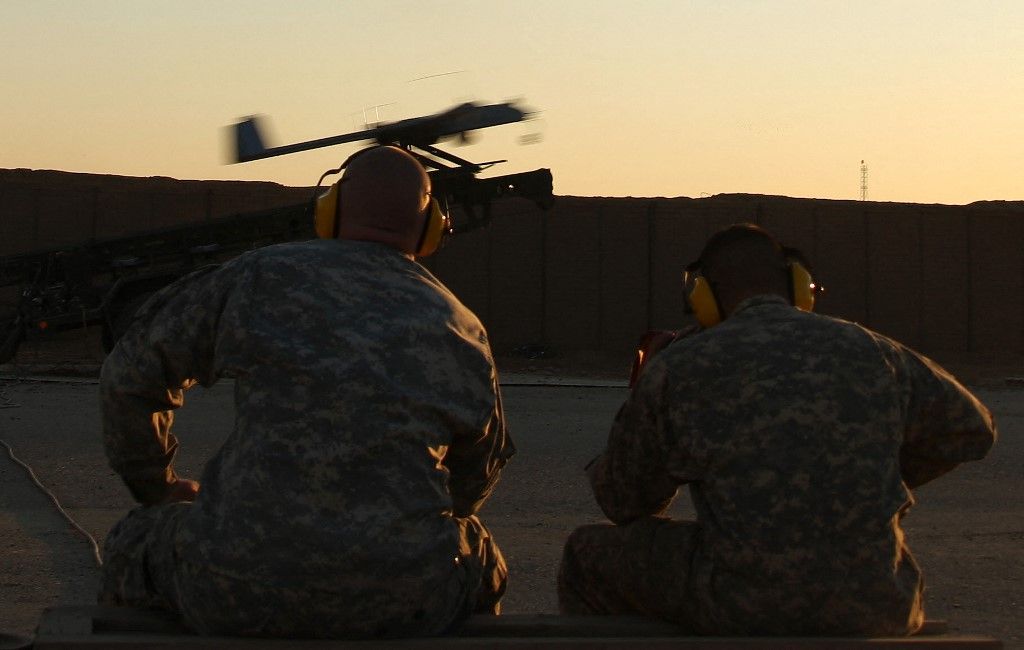 US army soldiers from Delta Troops, TF2-1CAV, 4-2 Stryker Brigade Combat Team (SBCT) watch an RQ-7B Shadow drone being launched from an army base near the restive city of Baquba, north of Baghdad, on February 22, 2008. The unmanned aerial vehicle (UAV) used for surveillance can fly between 3,000 to 15,000 feet and has an autonomy of six hours. Baquba, is the capital of Diyala province which is now considered the most dangerous area in Iraq after US and Iraqi forces chased Al-Qaeda insurgents out of their strongholds in Baghdad and surrounding areas. AFP PHOTO/PATRICK BAZ (Photo by PATRICK BAZ / AFP)