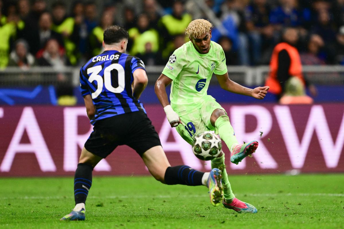 Barcelona's Spanish forward #19 Lamine Yamal (R) shoots the ball past Inter Milan's Brazilian defender #30 Carlos Augusto during the UEFA Champions League semi-final second leg football match between Inter Milan and FC Barcelona at the San Siro stadium in Milan on May 6, 2025. (Photo by Marco BERTORELLO / AFP)