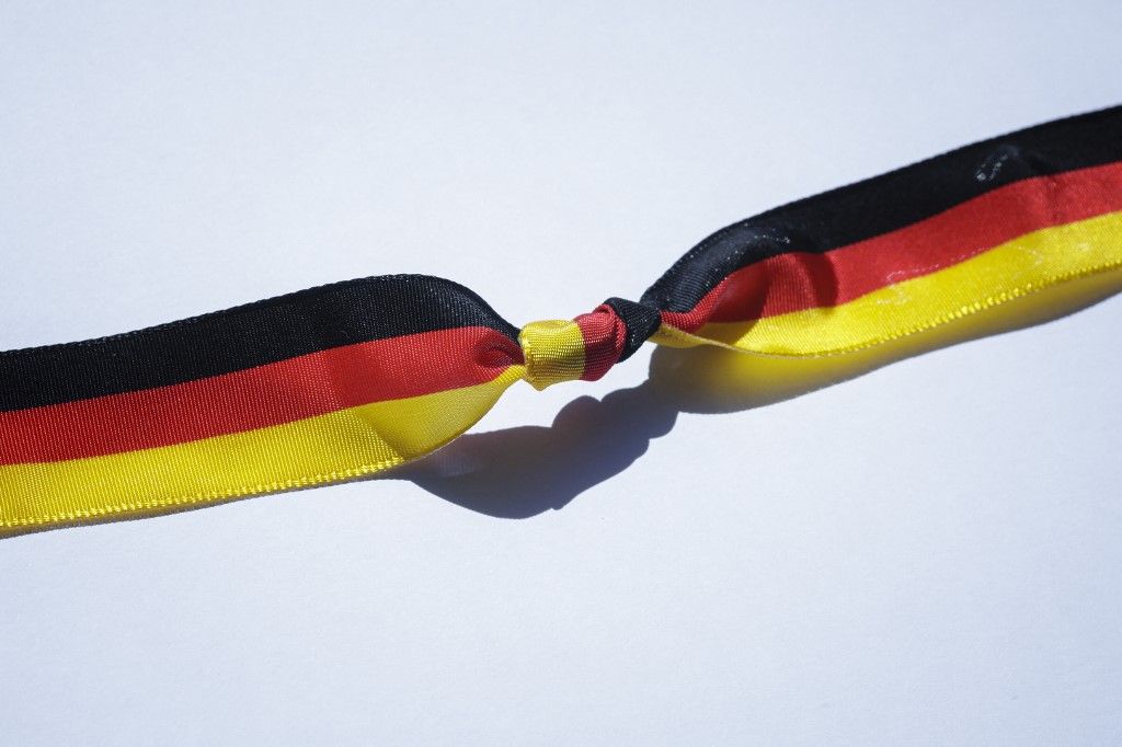 Symbolic photo: Knot in a ribbon with the colors of the Federal Republic of Germany. Berlin, May 6, 2025. (Photo by Thomas Trutschel / Photothek Media Lab / dpa Picture-Alliance via AFP)