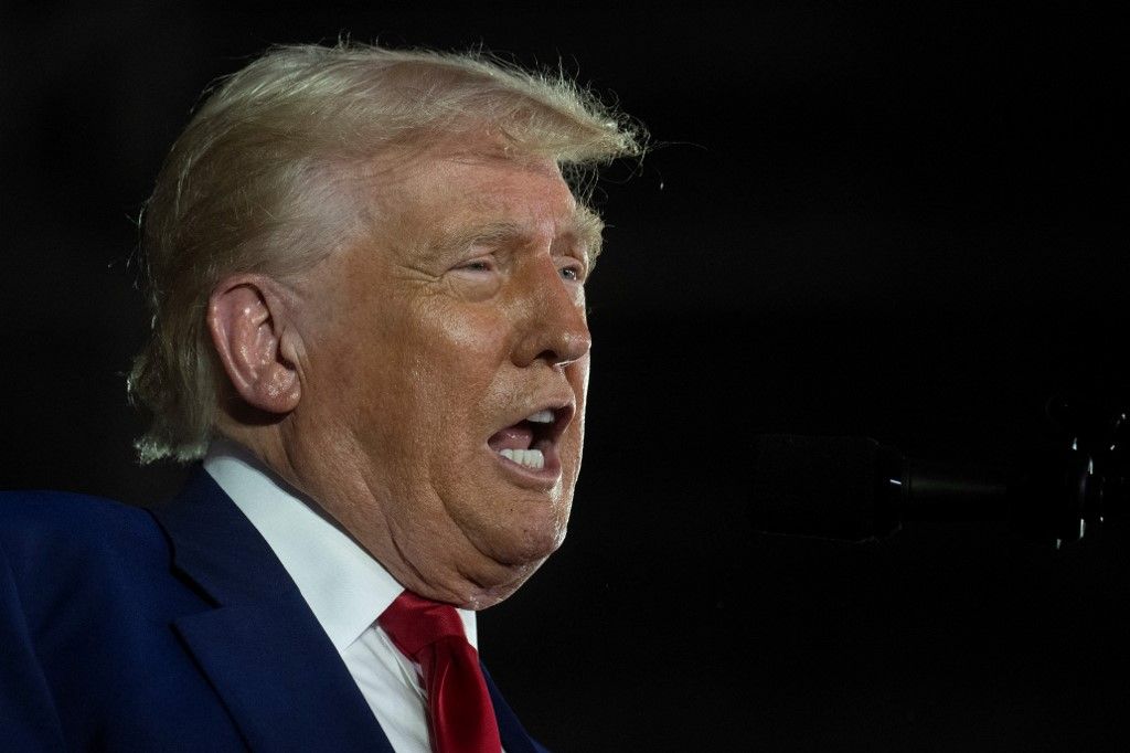 US President Donald Trump delivers a speech marking his 100th day in office at Macomb County Community College Sports Expo Center in Warren, Michigan, on April 29, 2025. Trump celebrated the first 100 days of what is already one of the most radical and far-reaching presidencies in US history, but polls show Americans becoming disenchanted with the economic and political tumult. (Photo by Jim WATSON / AFP)