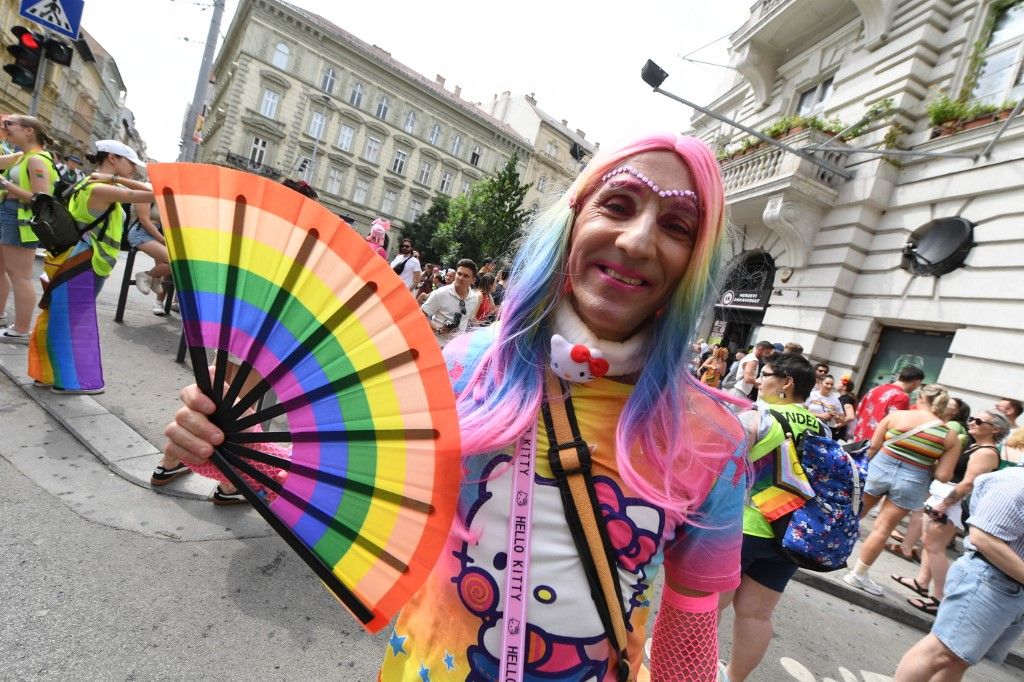 A participant poses with a fan in rainbow colors during the Budapest Pride Parade in Budapest, Hungary on June 22, 2024. (Photo by Ferenc ISZA / AFP)