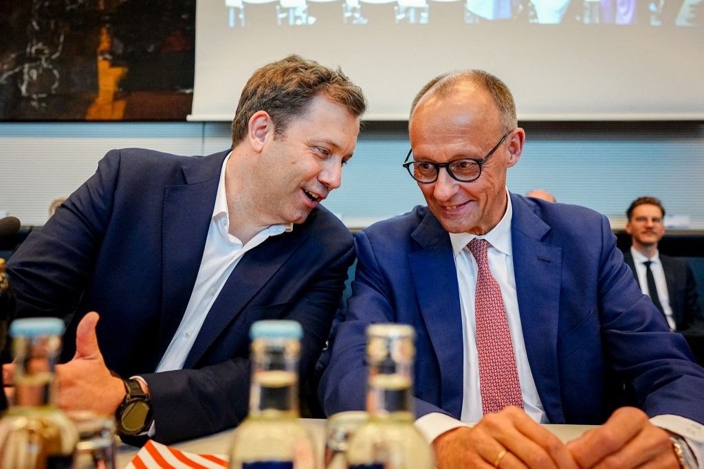 dpatop - 05 May 2025, Berlin: Lars Klingbeil (l), SPD federal chairman and designated finance minister, and Friedrich Merz, CDU candidate for chancellor and CDU federal chairman, take part in the SPD parliamentary group meeting. Photo: Kay Nietfeld/dpa (Photo by KAY NIETFELD / DPA / dpa Picture-Alliance via AFP)